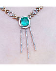 A closer left side view of a kisses and hugs necklace with a square natural Colombian emerald prong set