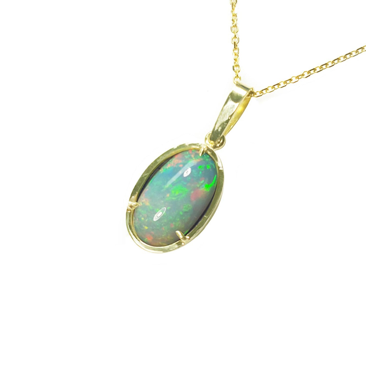 Ethiopian Welo opal pendant with gold frame on a left-side profile on a white background.