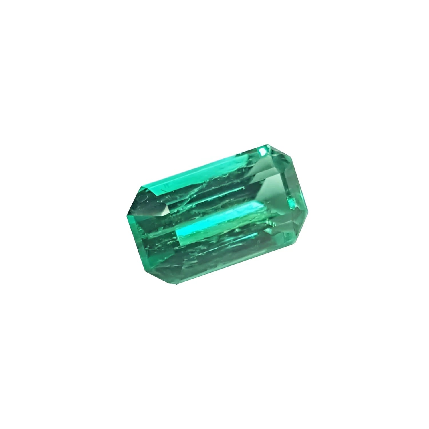 Emerald gemstone, rectangular cut, deep green, isolated on white.