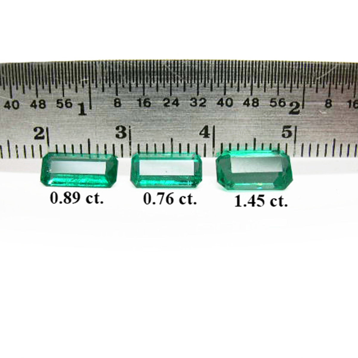 Loose emeralds matched trio set for earrings and pendant, front side with a ruler sizer