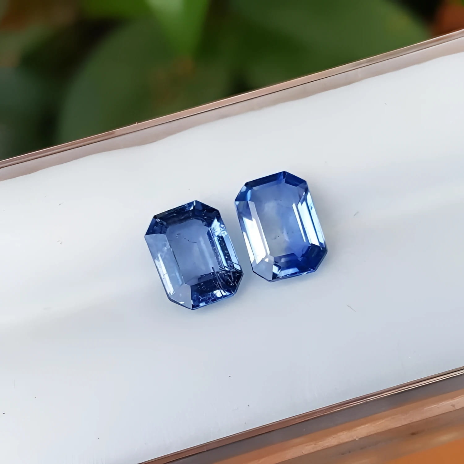 2.16 ct. loose matching pair of sparkling emerald-cut blue sapphires.