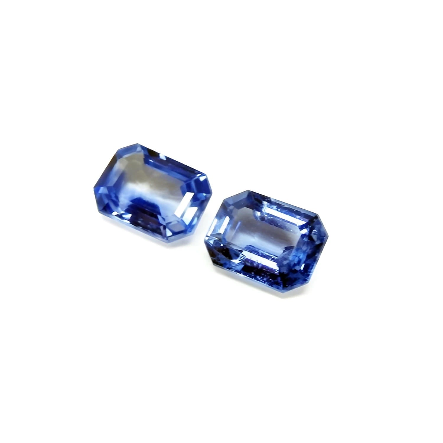 2.16 ct. loose matching pair of sparkling emerald-cut blue sapphires, ideal for earrings.
