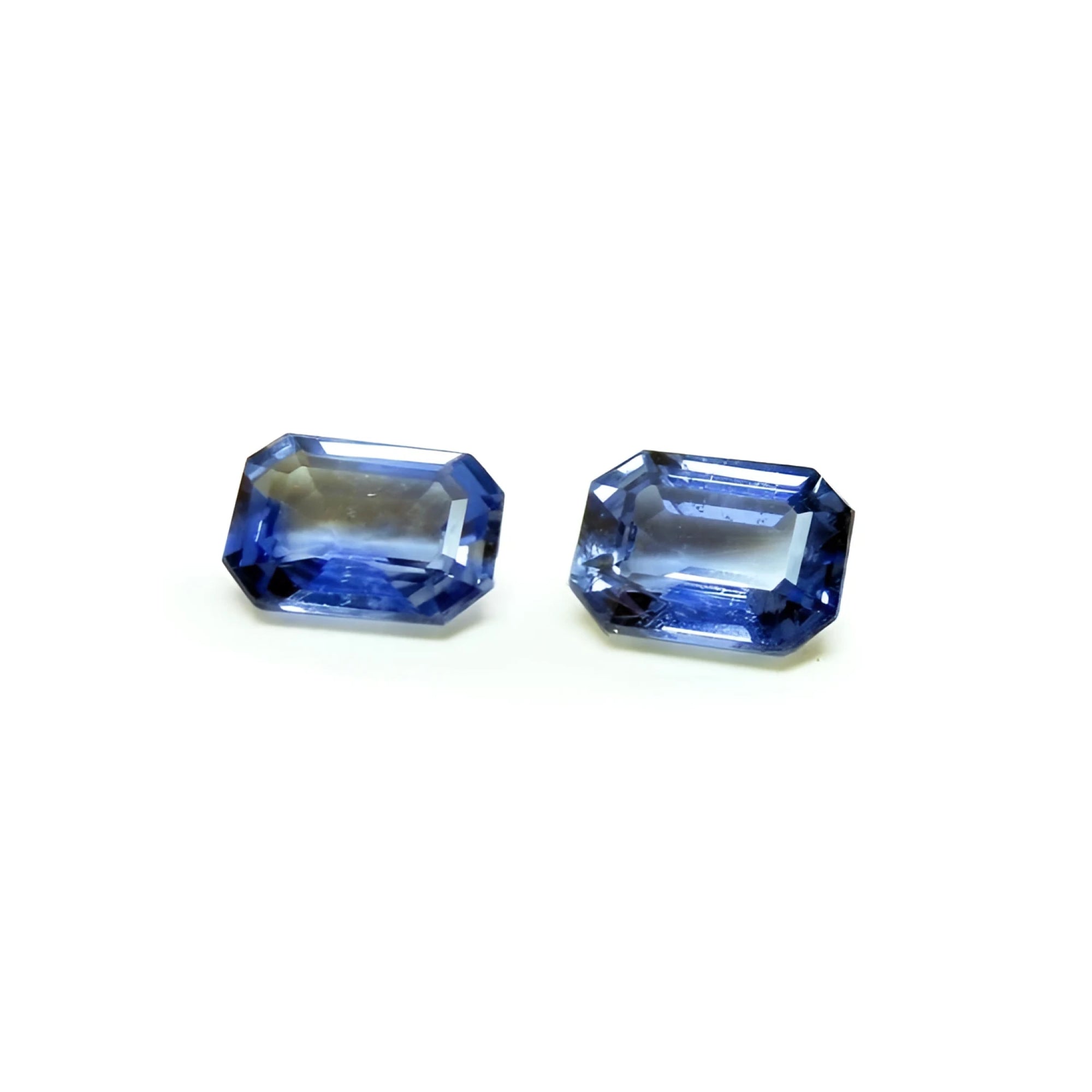 2.16 ct. Loose matching pair blue sapphires emerald-cut, crystalline medium light blue violet color, ideal for crafting elegant earrings.