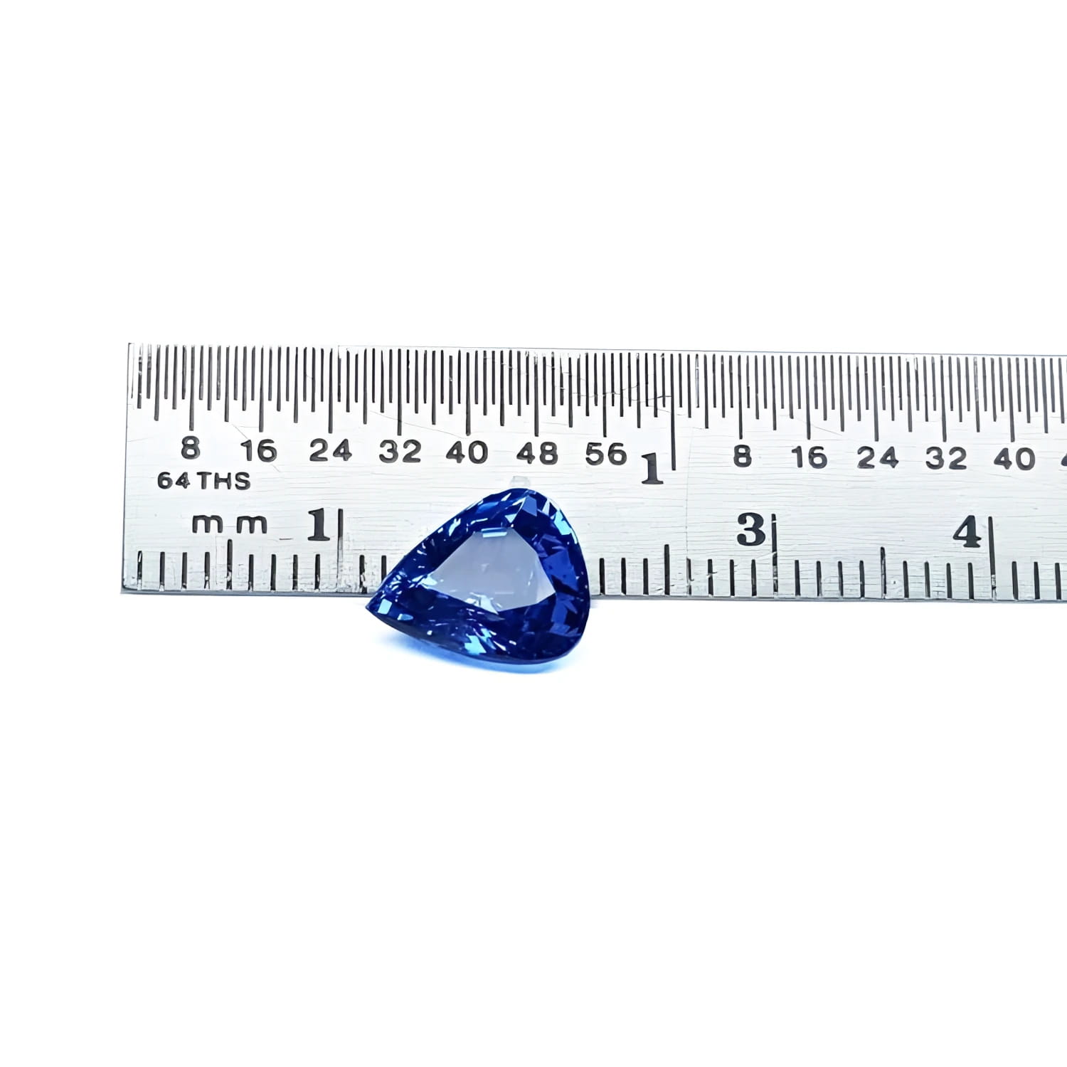 3.30 ct. vibrant medium blue pear-shaped natural sapphire gemstone next to a ruler.
