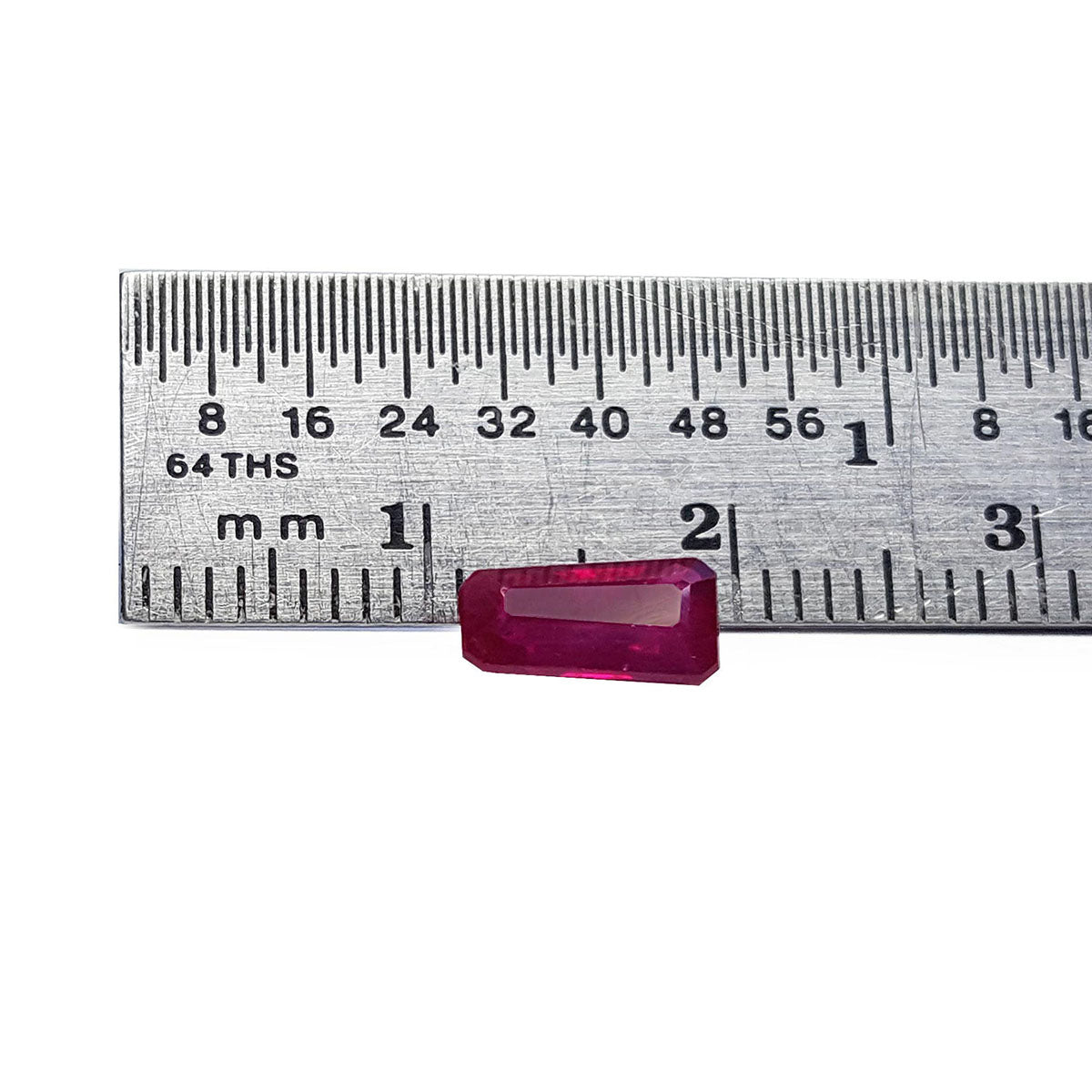 Natural loose ruby tapered baguette cut Burma gemstone 1.07 ct. front side position with a ruler measurer