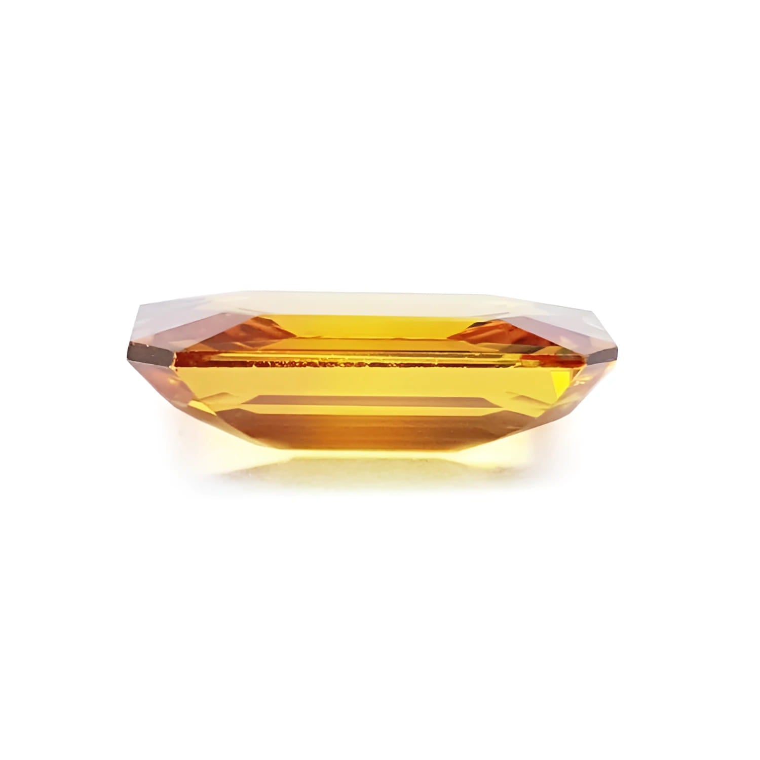 Vibrant 4.05 ct. natural yellow sapphire, emerald-cut, on a white background.
