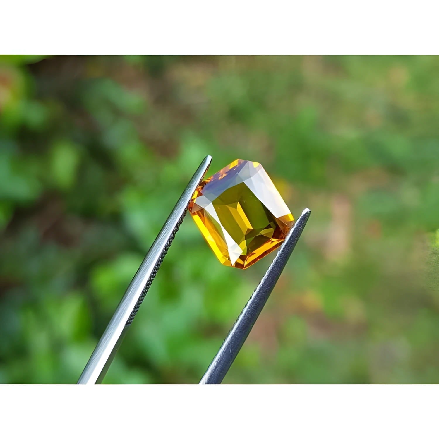 2.96 ct. loose natural yellow Madeira radiant cut sapphire held by tweezers.
