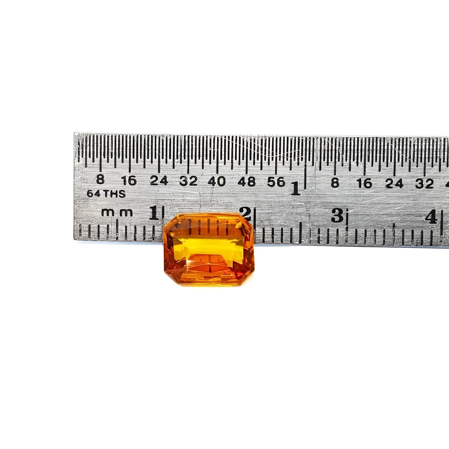 2.96 ct. loose natural yellow Madeira sapphire, radiant cut, displayed next to a ruler.