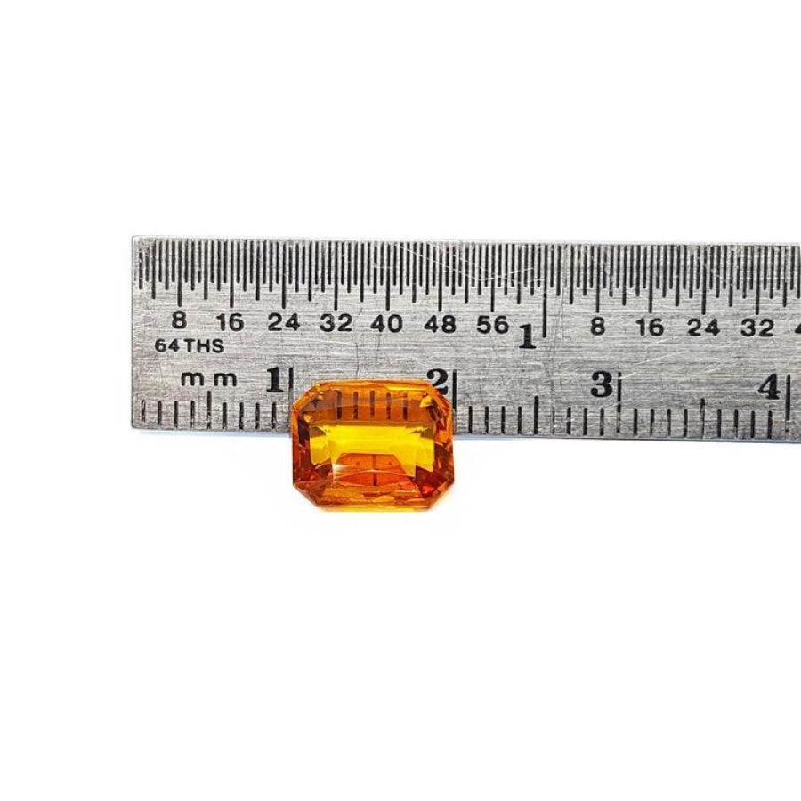 2.96 ct. loose natural yellow Madeira sapphire, radiant cut, displayed next to a ruler.