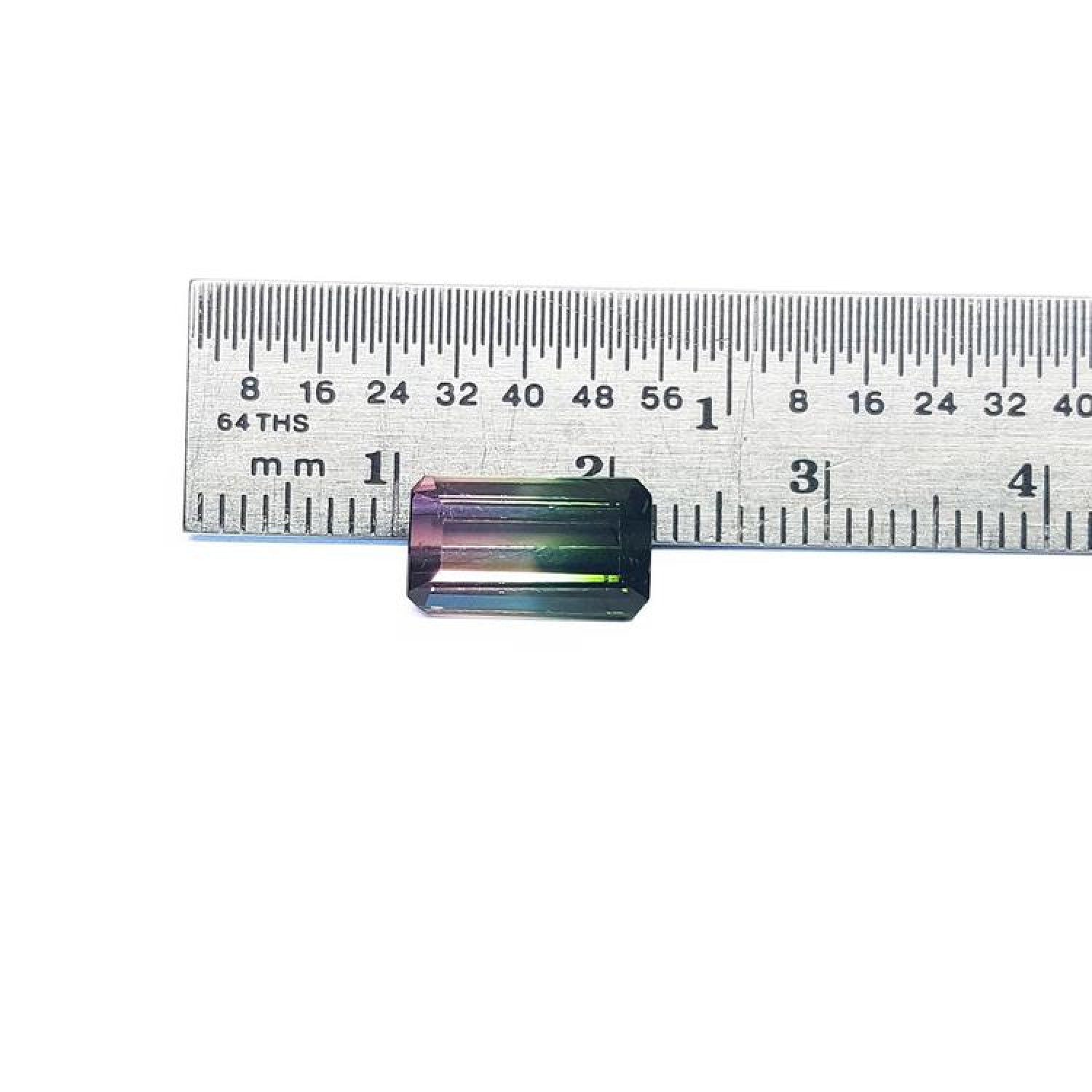 3.20 ct. loose emerald-cut watermelon tourmaline, strong green to soft pink, displayed with a ruler.
