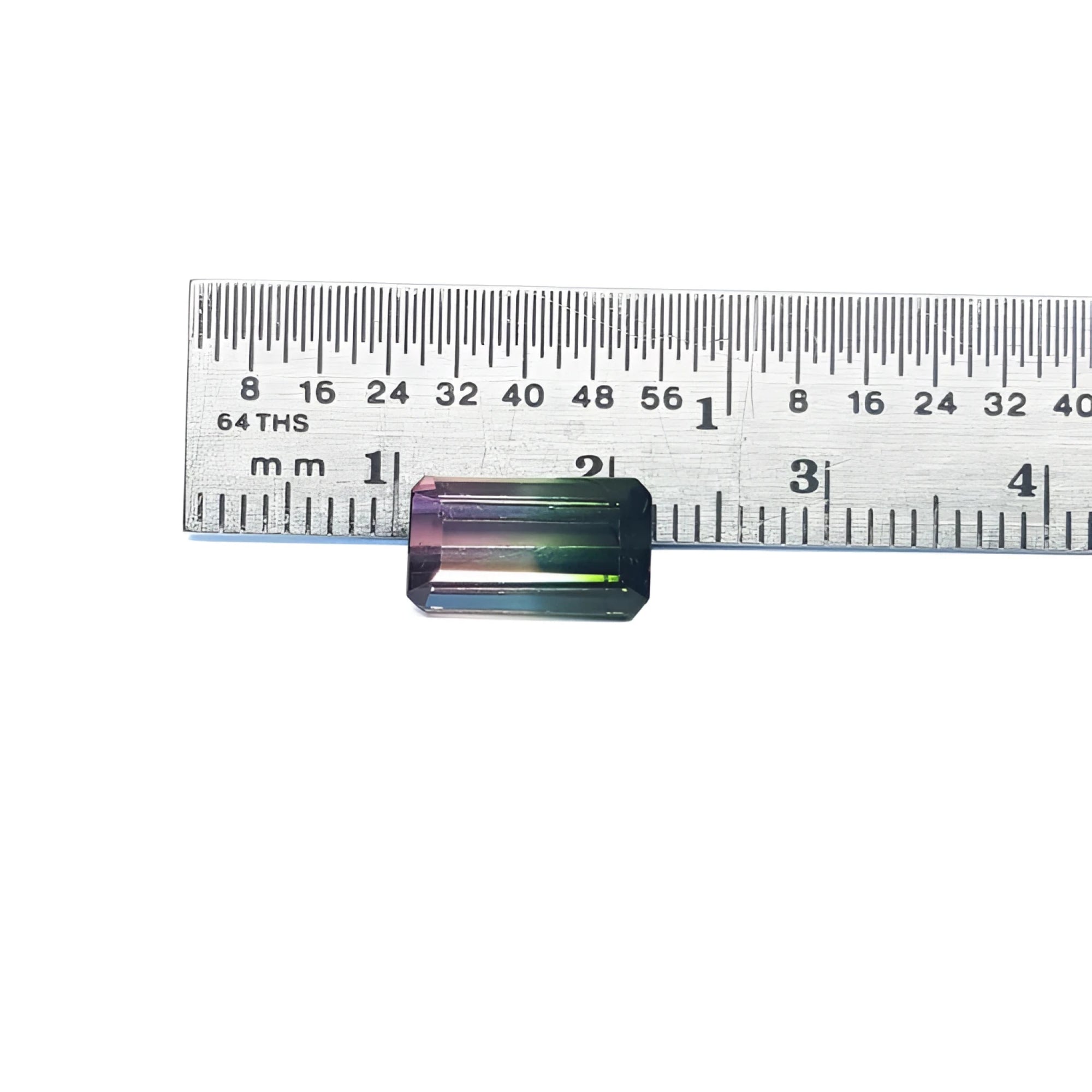 3.20 ct. loose emerald-cut watermelon tourmaline, strong green to soft pink, displayed with a ruler.