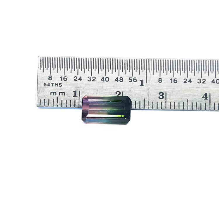 3.20 ct. loose emerald-cut watermelon tourmaline, strong green to soft pink, displayed with a ruler.