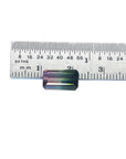 A watermelon tourmaline on a ruler for size measure.