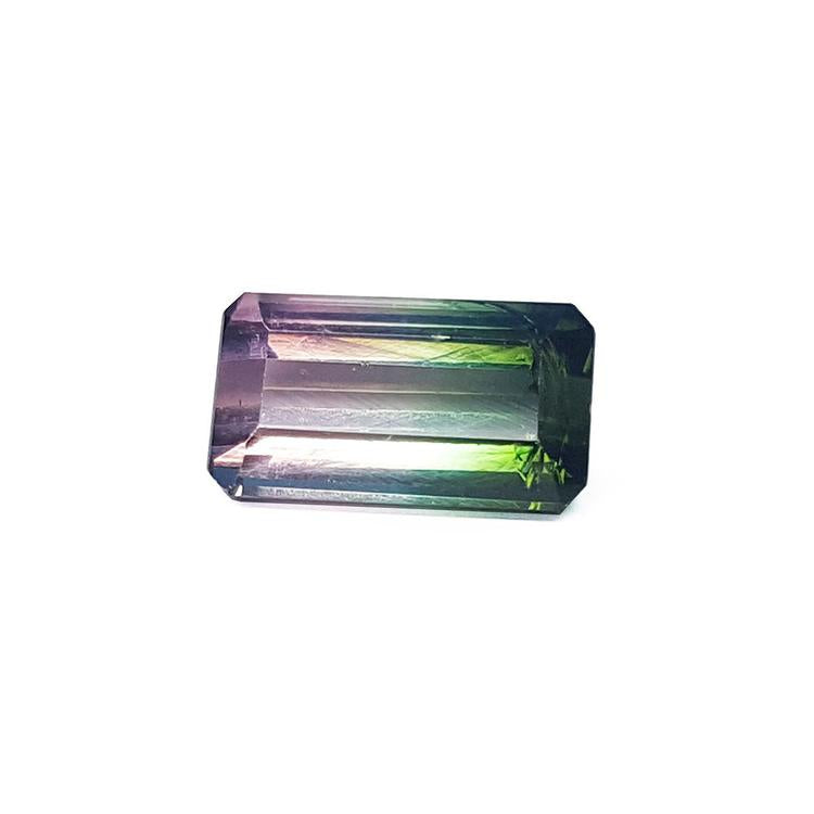A rectangular emerald cut natural brazilian tourmaline displaying the topside table and crown faces.