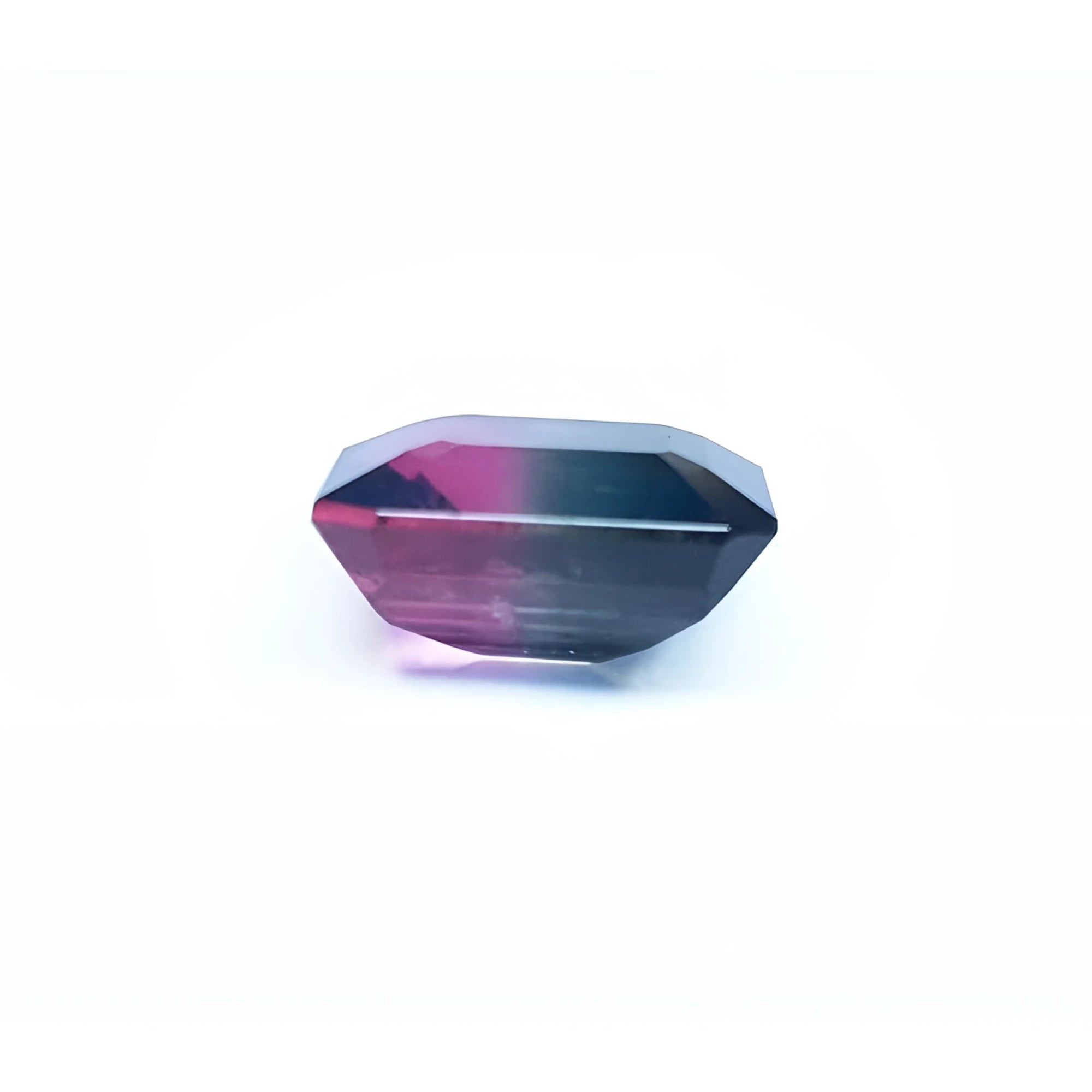 7.75 ct. emerald-cut Brazilian watermelon tourmaline gemstone with vibrant red-orange and deep bluish-green bicolor.