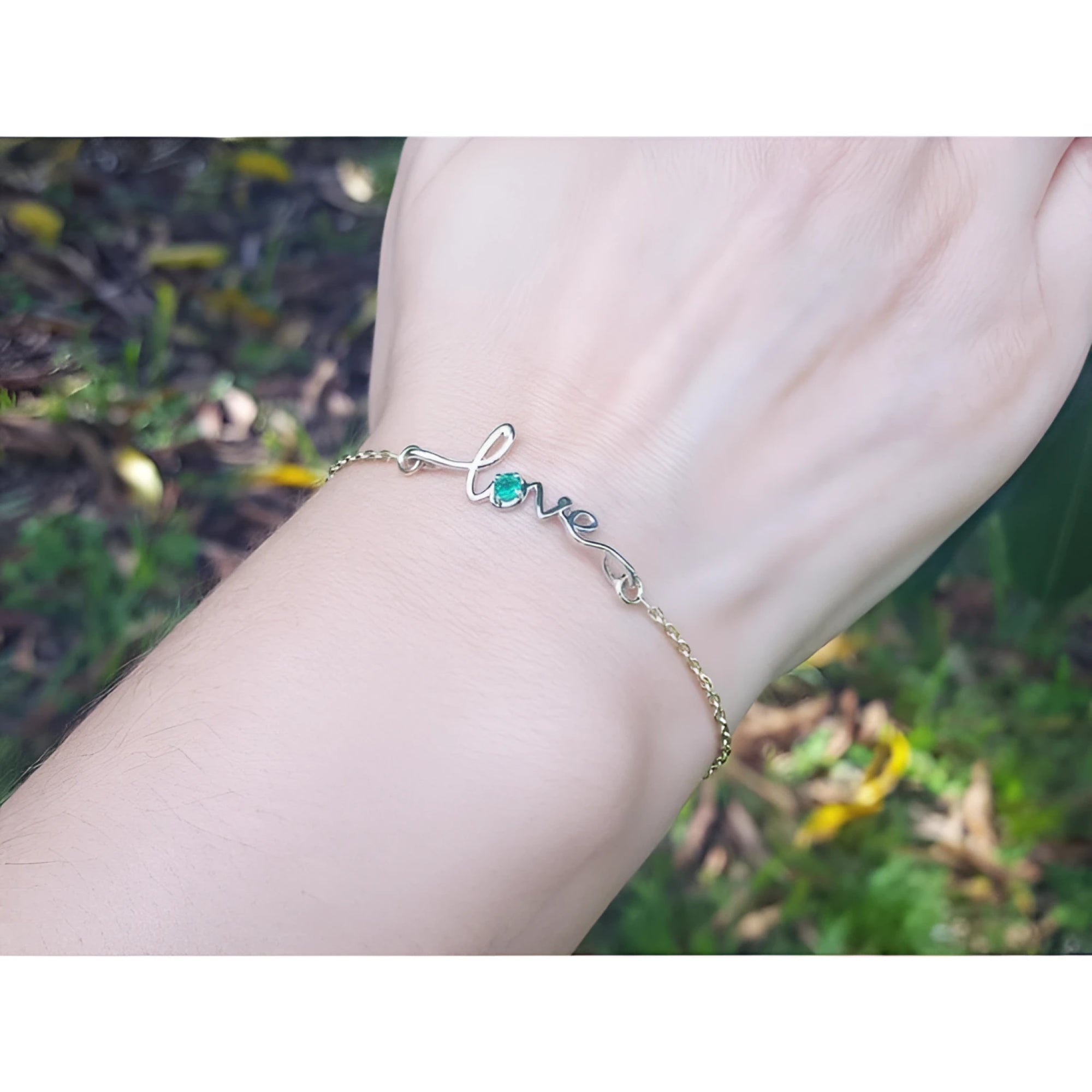 Emerald Love Bracelet: 14K white and yellow gold with a round cut Colombian emerald.