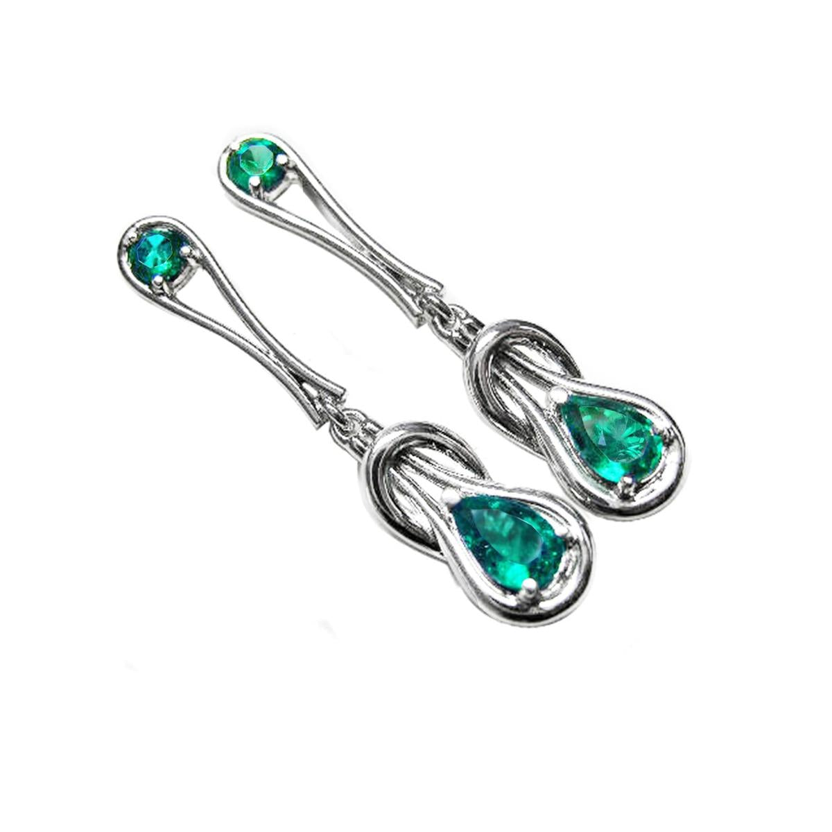Pair of Love Knot emerald earrings pear cut in white gold on a white background