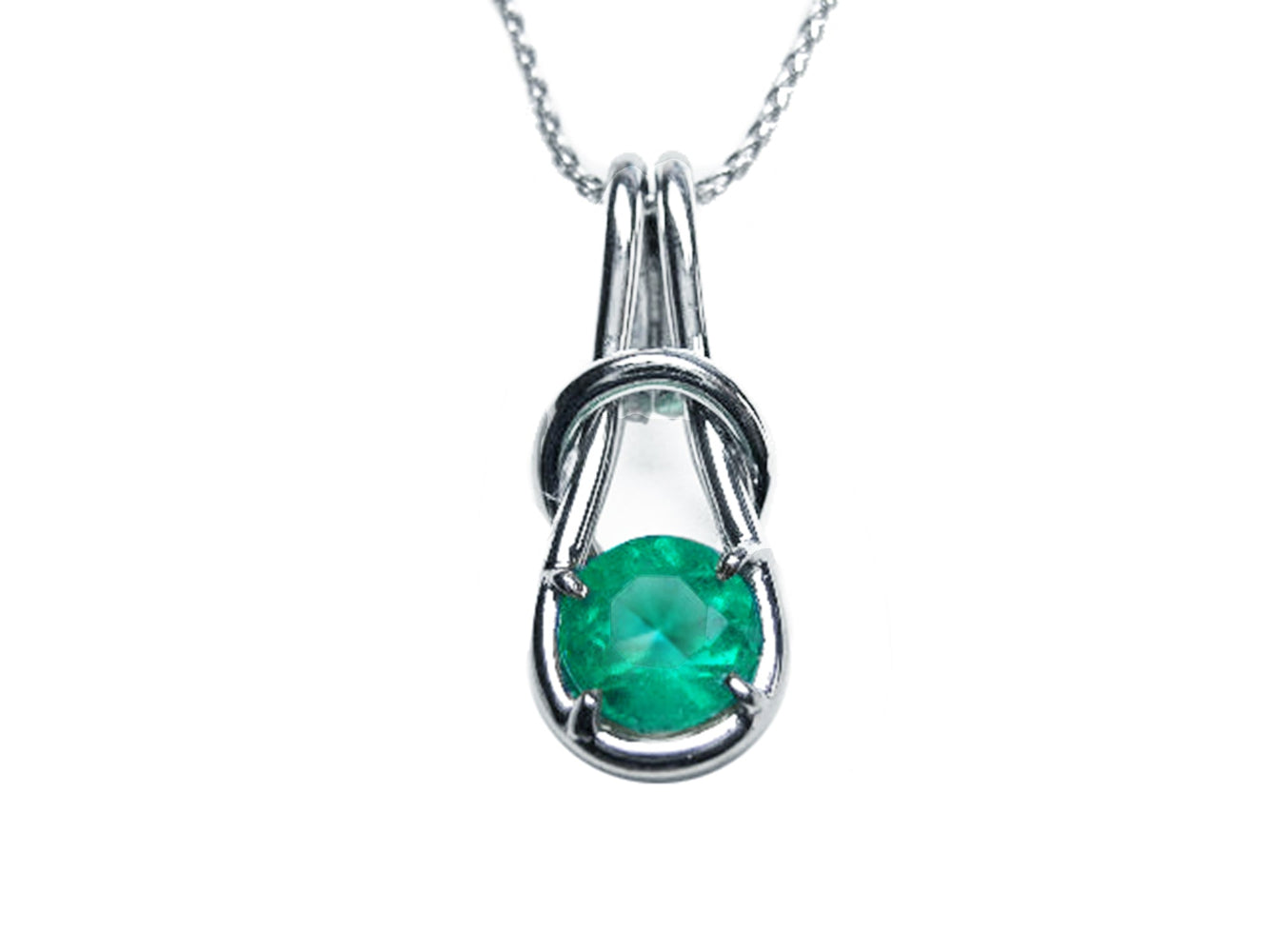 A white gold love knot pendant necklace with a round cut natural colombian emerald topside view.
