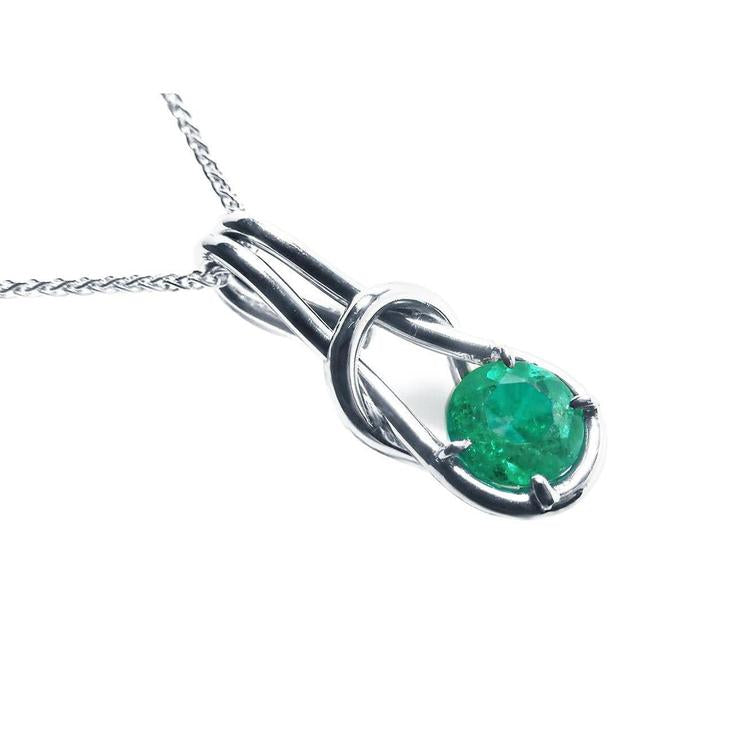 Love knot natural emerald pendant necklace in 14k white gold, top and right-side profile view.