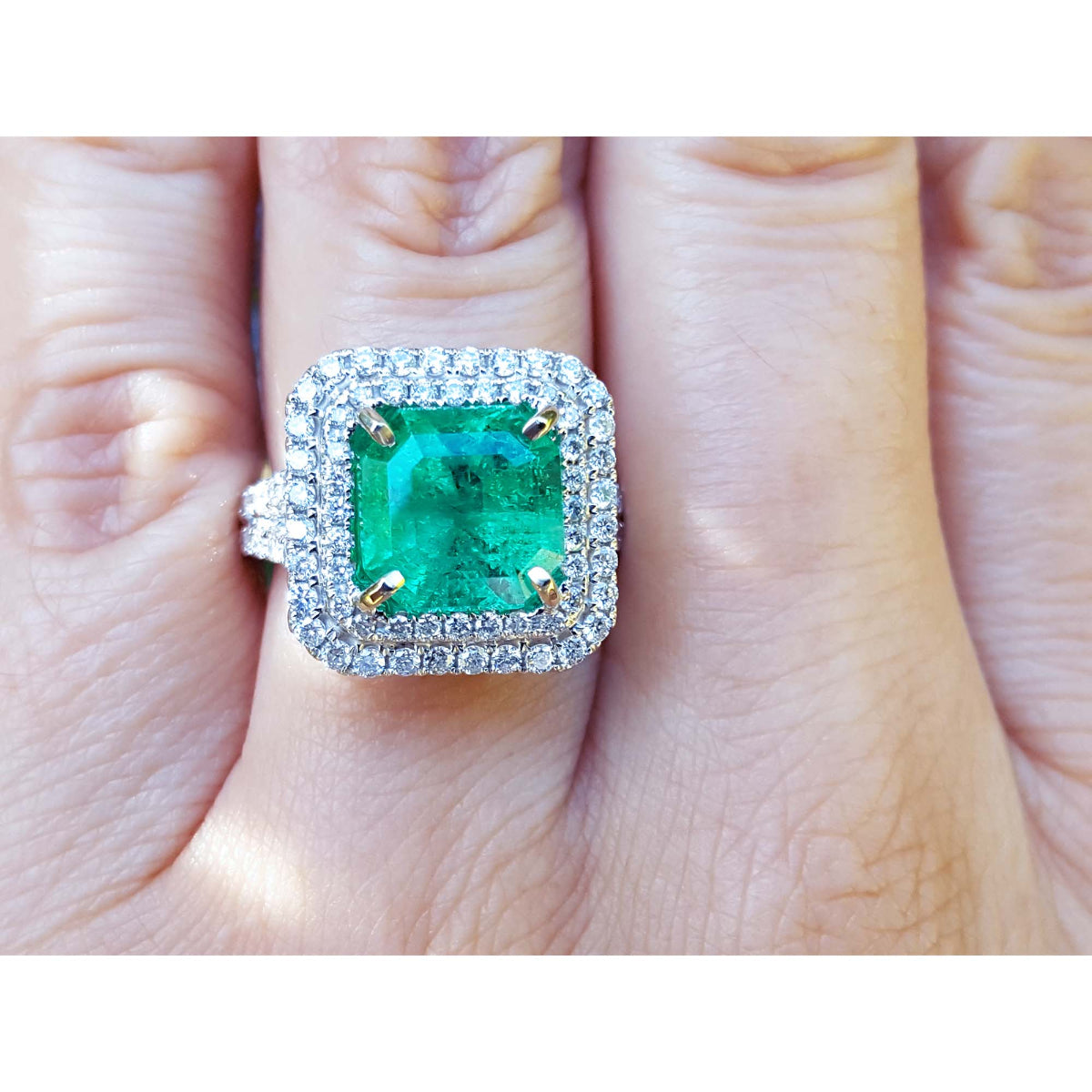 Natural colombian emerald ring GIA certified in a halo natural diamond crafted in 14k white gold.