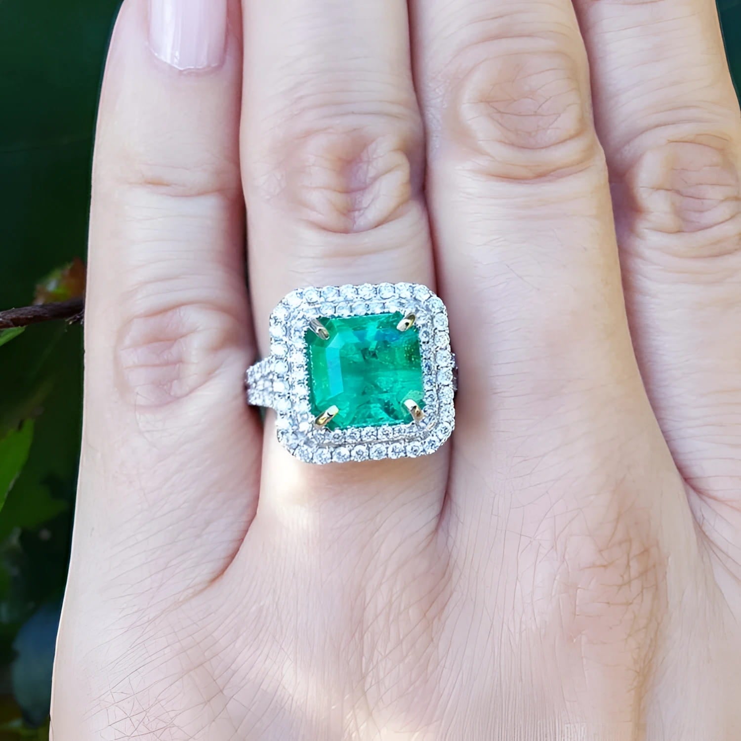 4.14 ct GIA-certified F1 Colombian emerald ring with diamond halo in 14K white gold.