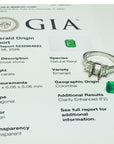 Emerald ring with GIA report on a white background