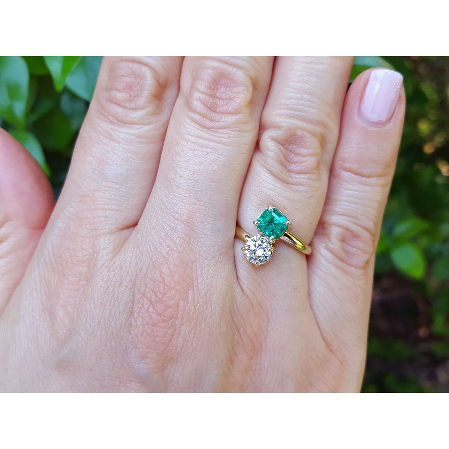 GIA Certified Toi et Moi Emerald and Diamond Ring 18k Gold on a women's hand.