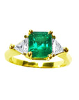 Natural colombian emerald three stone ring with side trillion cut diamonds for women, crafted in 18k yellow gold.