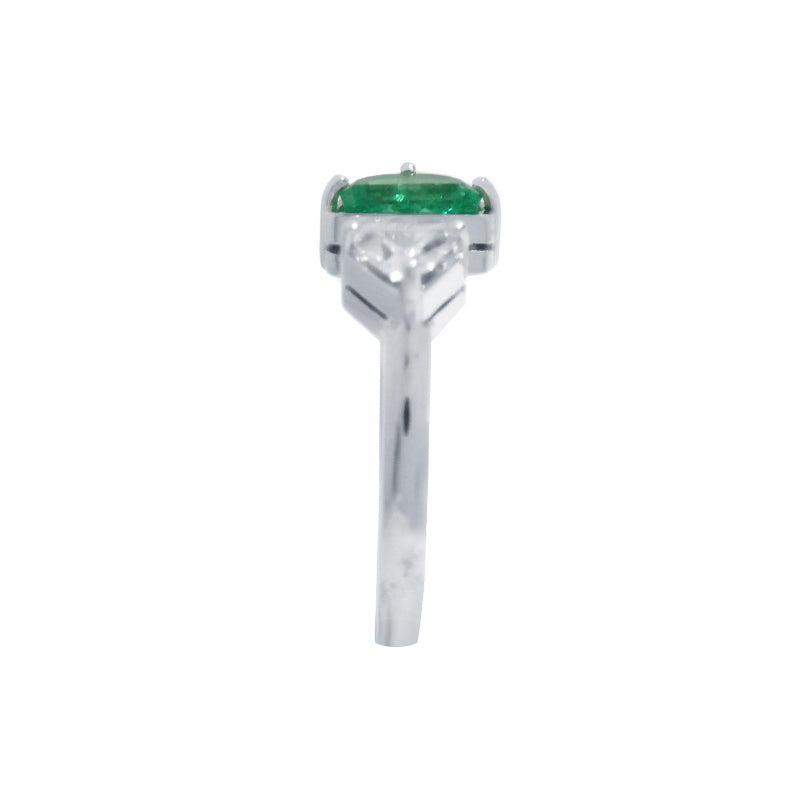 The emerald showcases fine quality with its distinctive fancy cut, while the geometric trillion diamond creates striking visual contrast.
