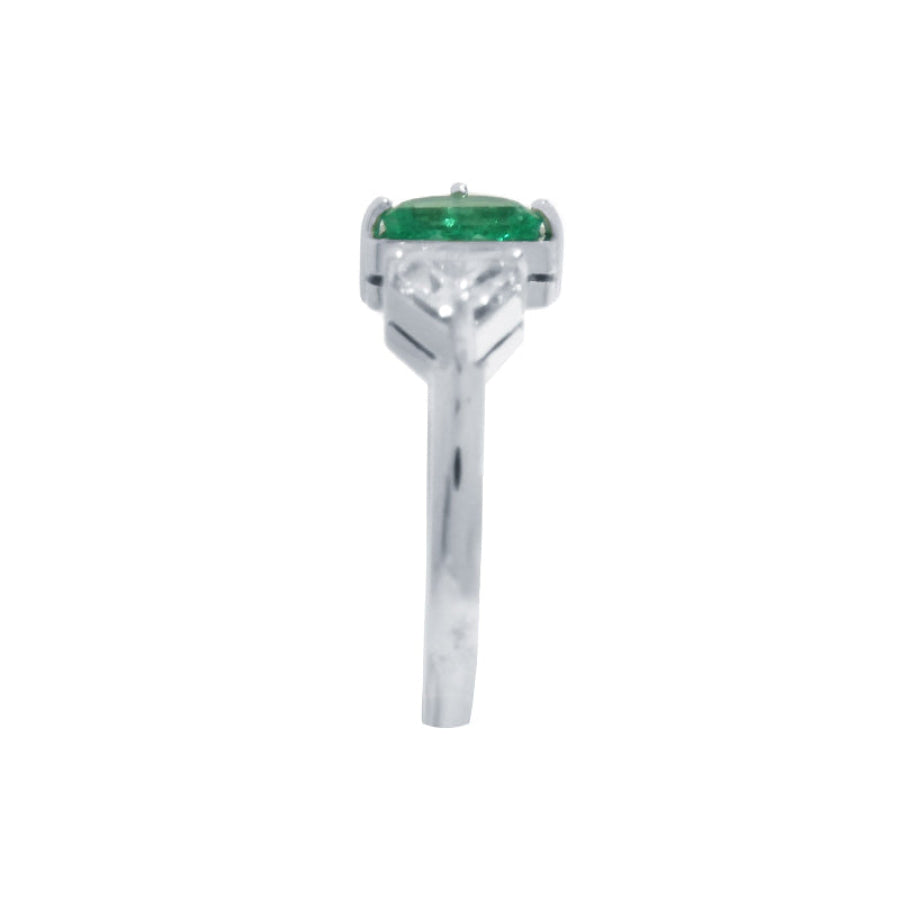 The emerald showcases fine quality with its distinctive fancy cut, while the geometric trillion diamond creates striking visual contrast.