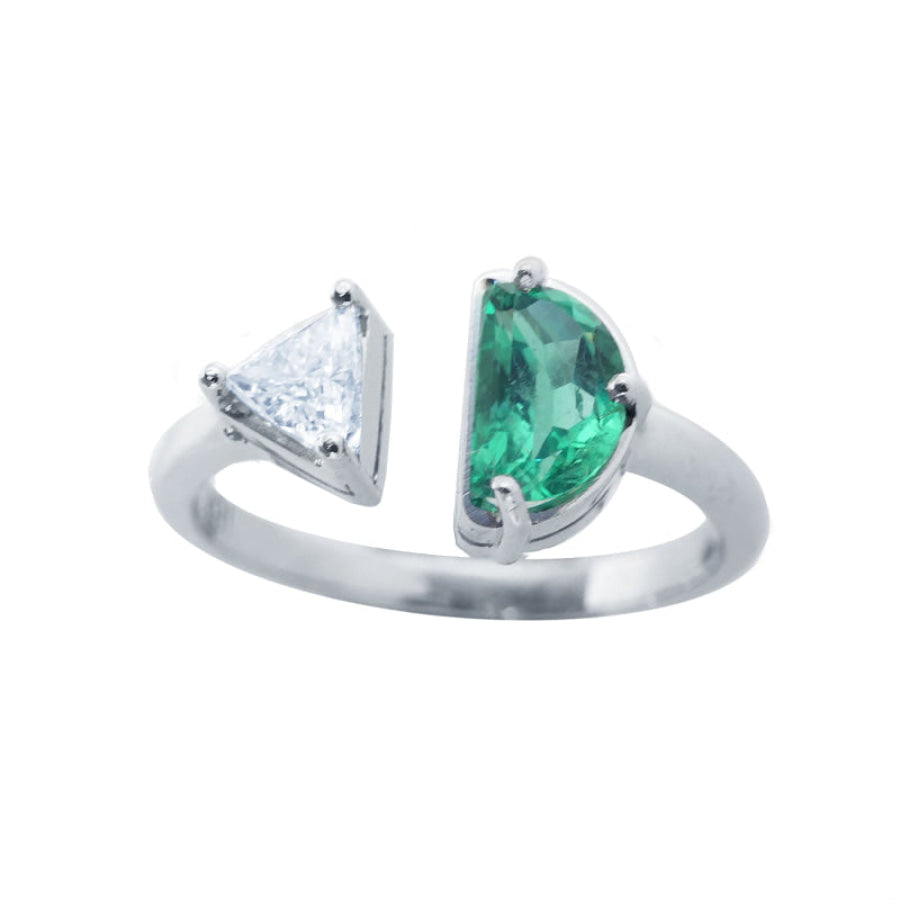 This negative space Toi et Moi ring features a half-moon-shaped natural Colombian emerald and a trillion-cut diamond.