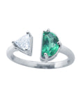 This negative space Toi et Moi ring features a half-moon-shaped natural Colombian emerald and a trillion-cut diamond.