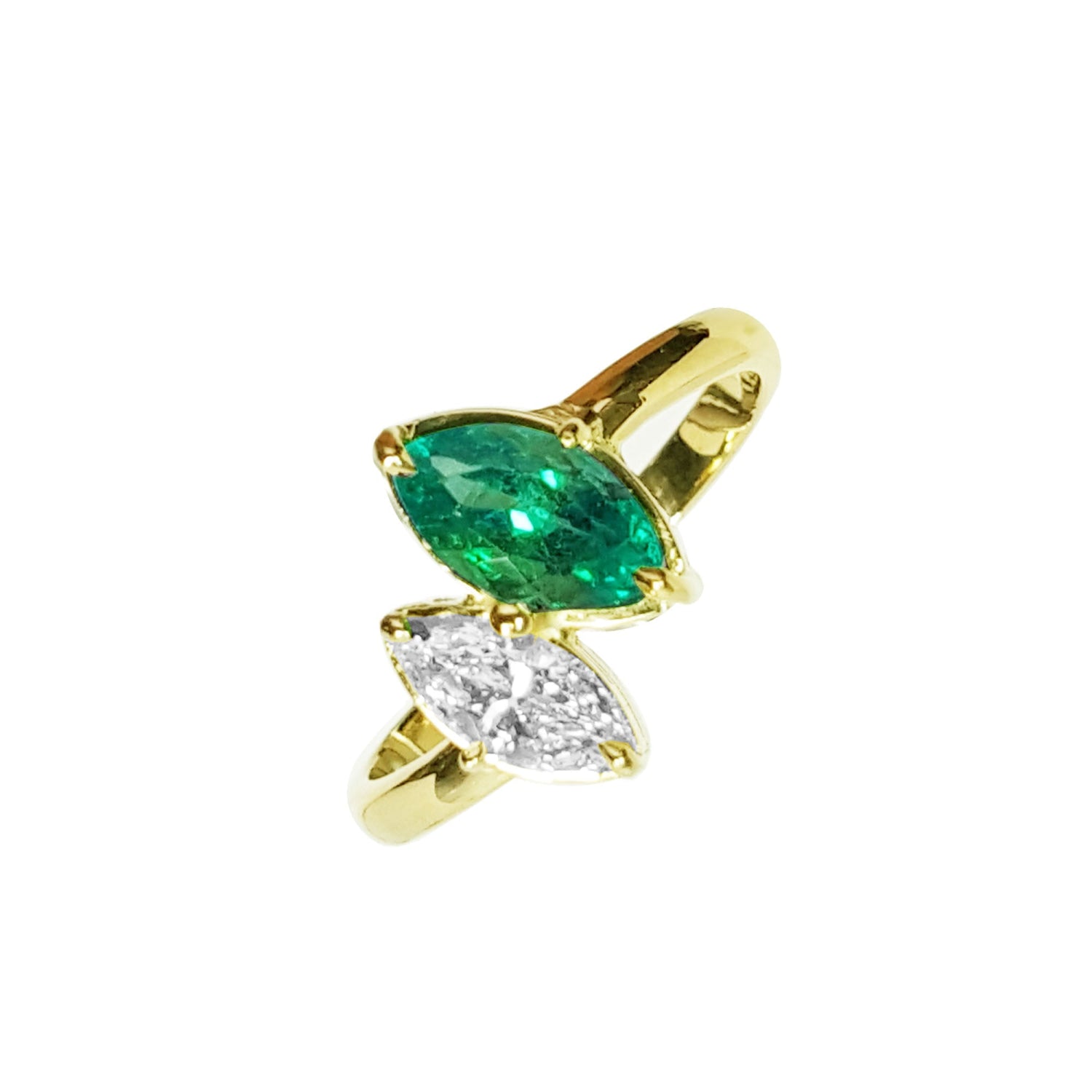 You and Me ring showcases a marquise-cut emerald paired with a natural diamond accent, all set in 18K yellow gold.