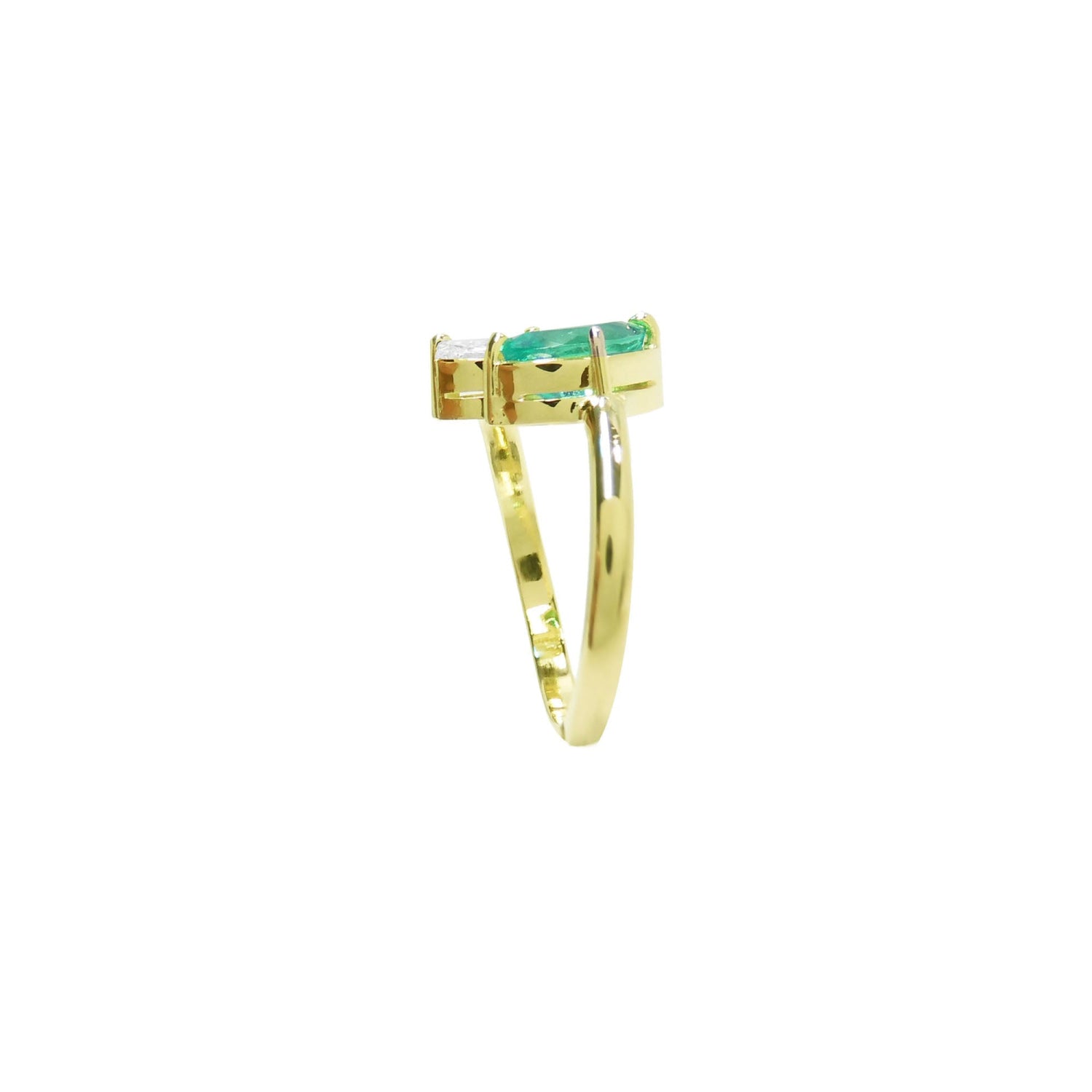 You and Me ring a marquise-cut emerald paired with a natural diamond accent, all set in 18K yellow gold.