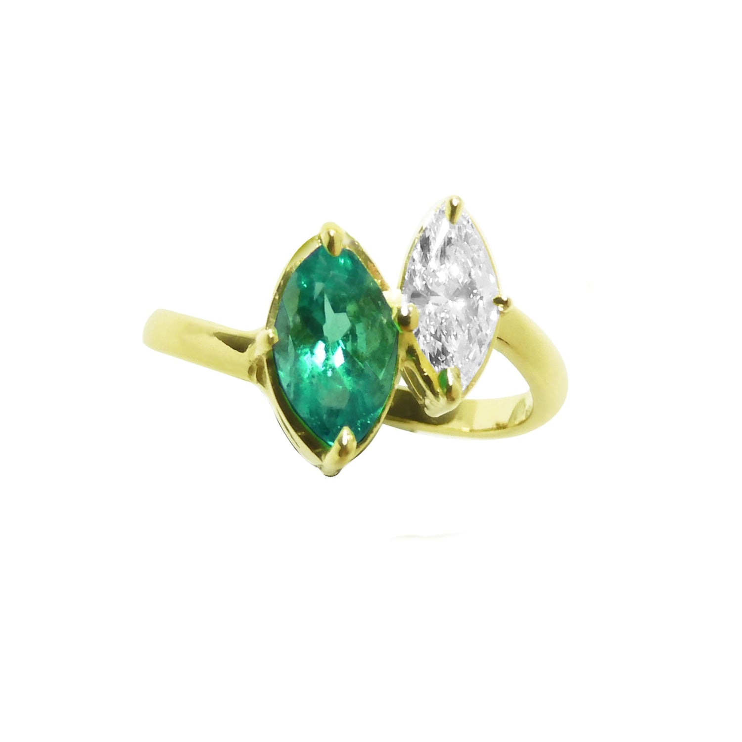 A 18k yellow gold you and me ring featuring a marquise-cut natural emerald and a marquise-cut diamond, toi et moi design.