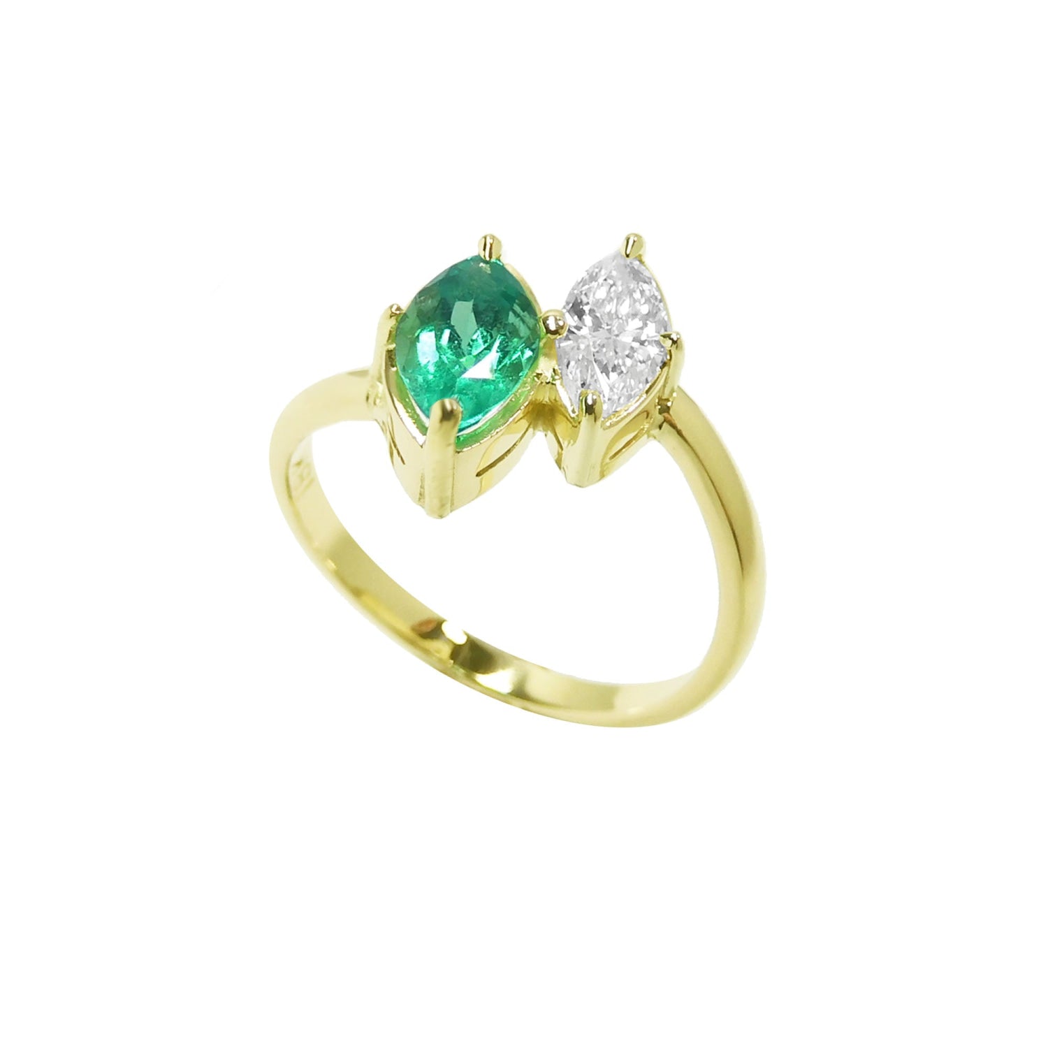 This stunning You and Me ring showcases a marquise-cut emerald paired with a natural diamond accent.