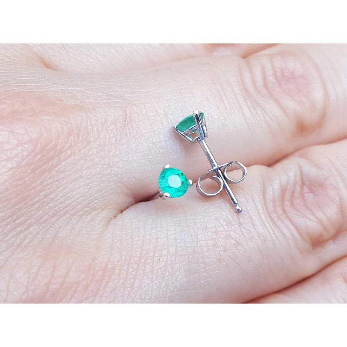 14K white gold martini stud earrings with round and pear-cut green emeralds, push backs.