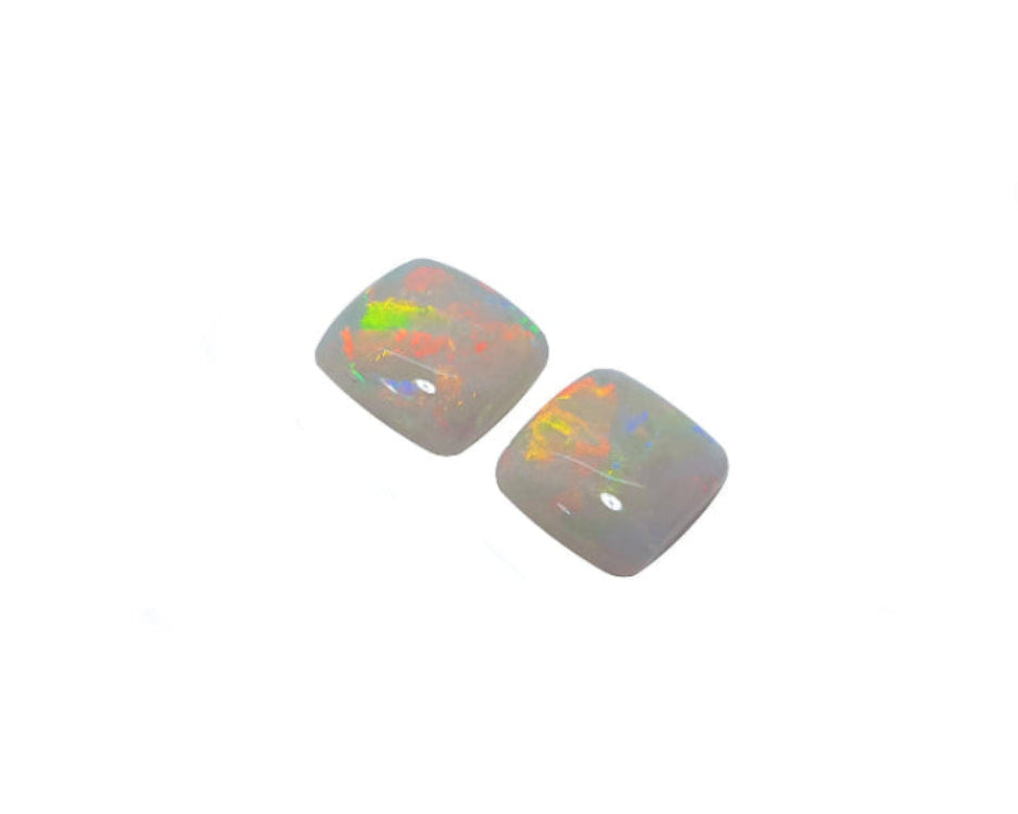 this matching pair of solid Australian opals are topside profile left position.