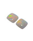 this matching pair of solid Australian opals are topside profile left position.