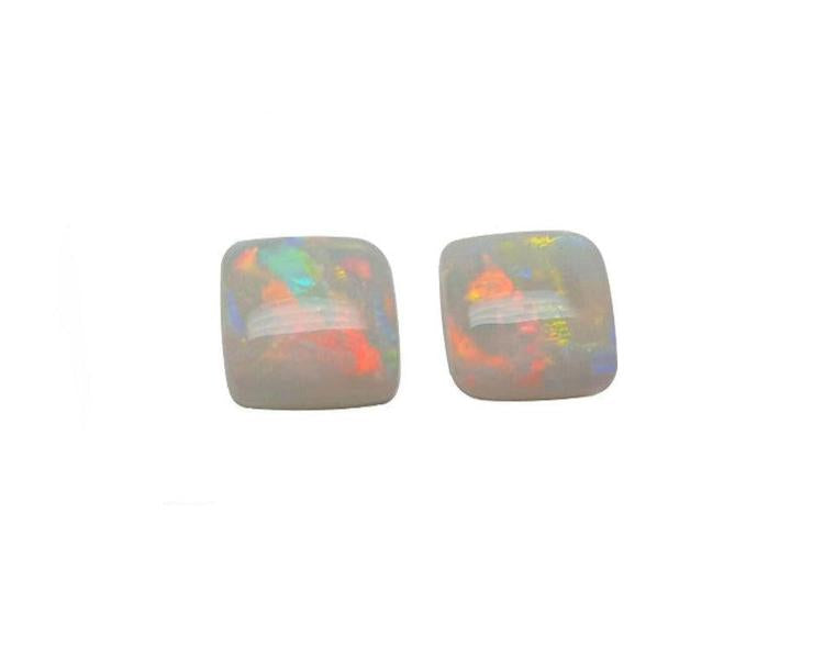 A matching pair for earrings of solid Australian opals multicolor hues cabochon square shaped, topside dome view.