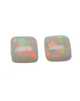 A matching pair for earrings of solid Australian opals multicolor hues cabochon square shaped, topside dome view.