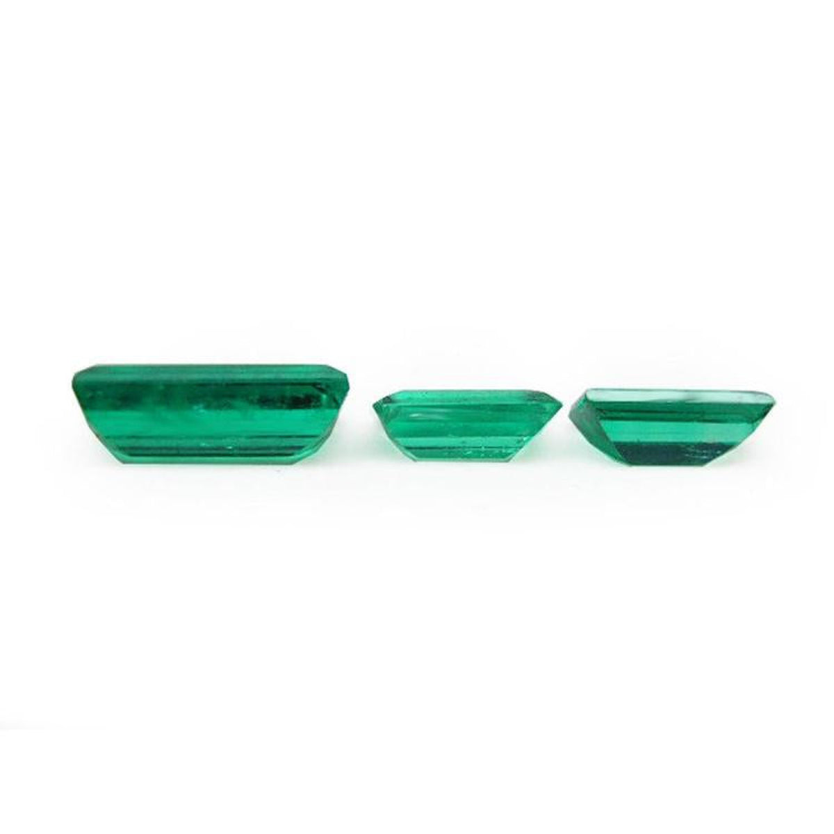 Matched trio set of baguette-cut natural loose Colombian emeralds in deep bluish-green.