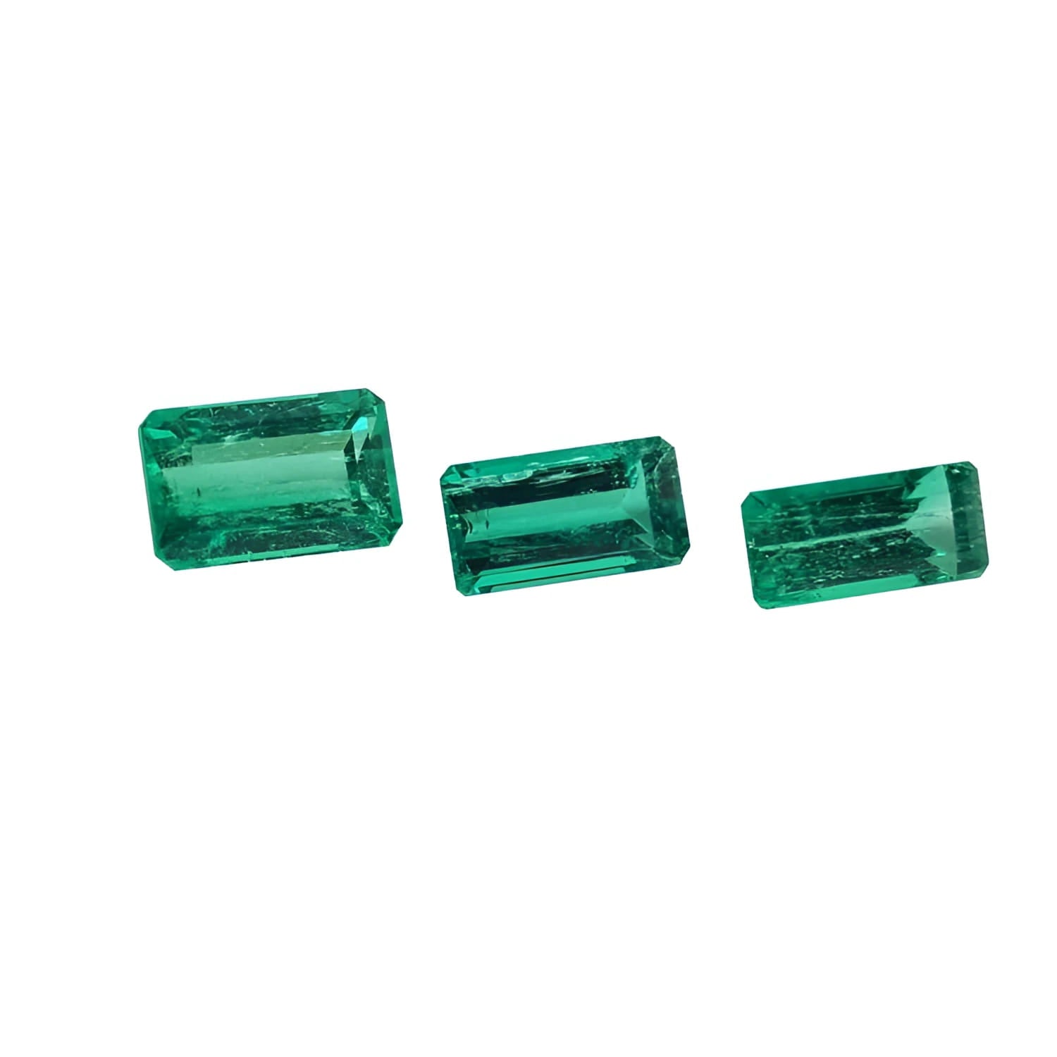 Three emerald-cut natural Colombian emeralds, varying in size, for earrings and pendant.