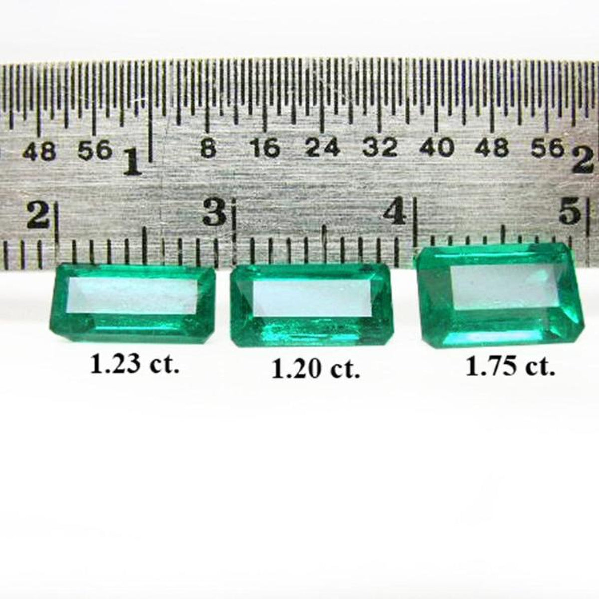 Three emerald-cut natural Colombian emeralds (1.23, 1.20, 1.75 ct) displayed with a ruler.