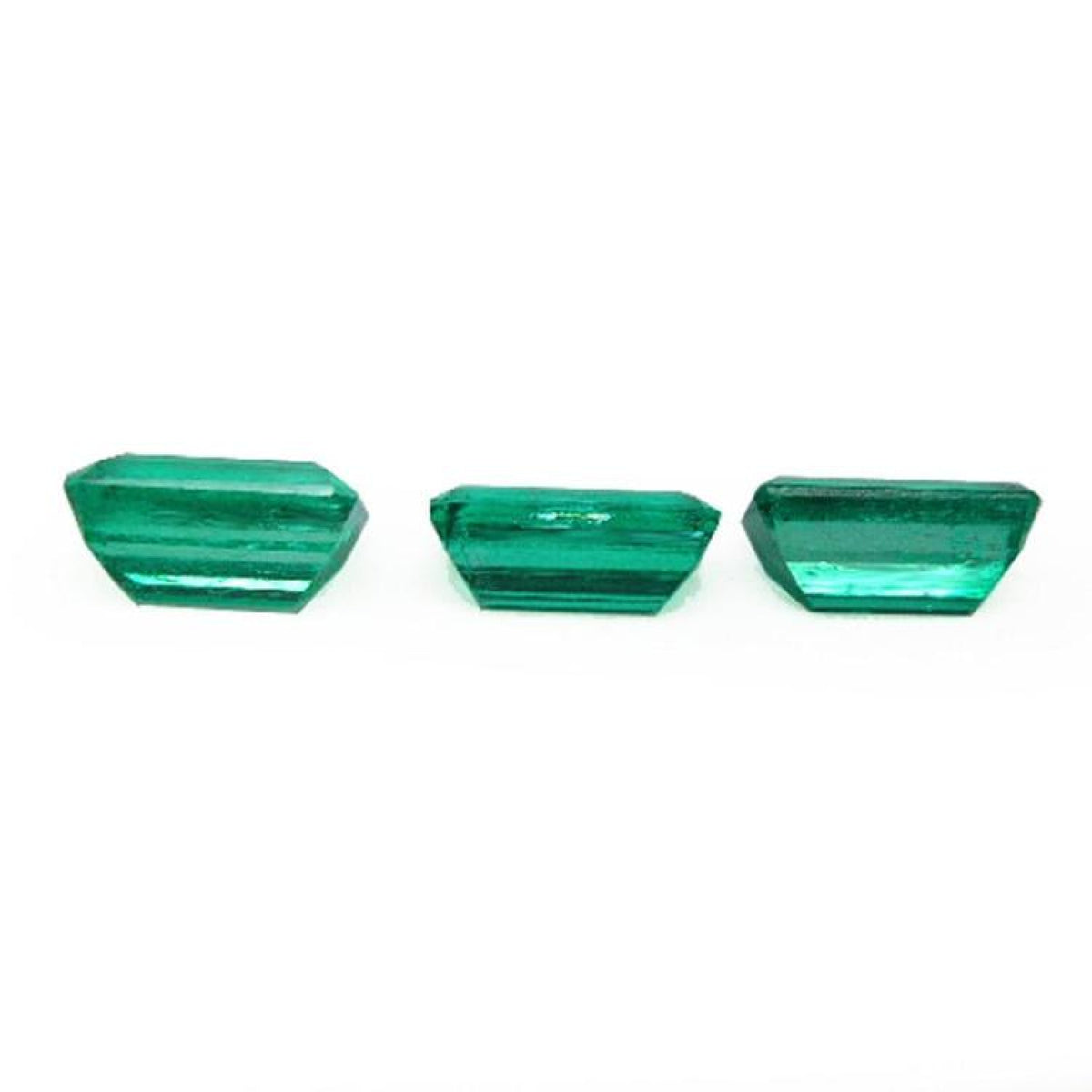 Three emerald-cut natural Colombian emeralds, a matched set for earrings and a pendant.