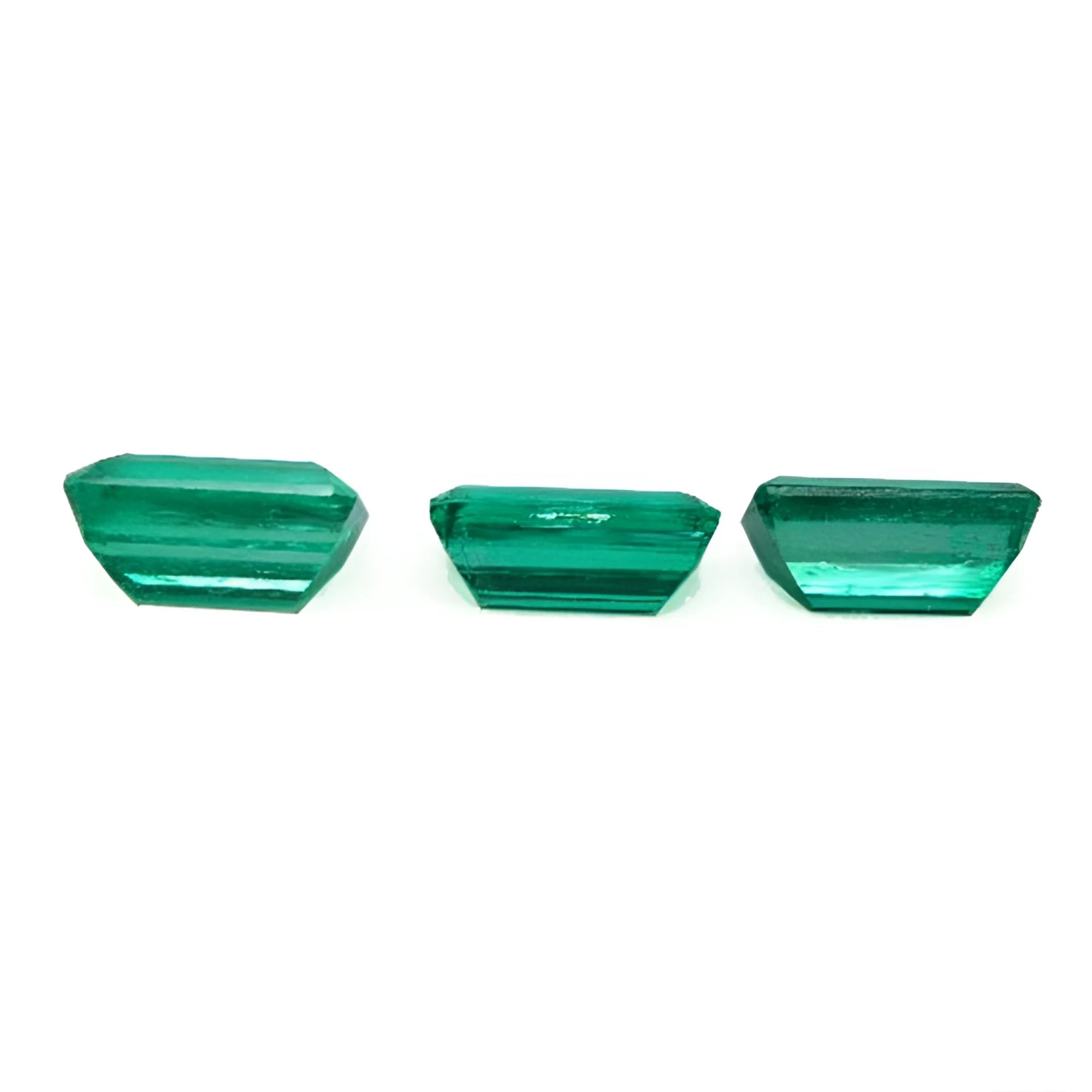 Three emerald-cut natural Colombian emeralds, a matched set for earrings and a pendant.