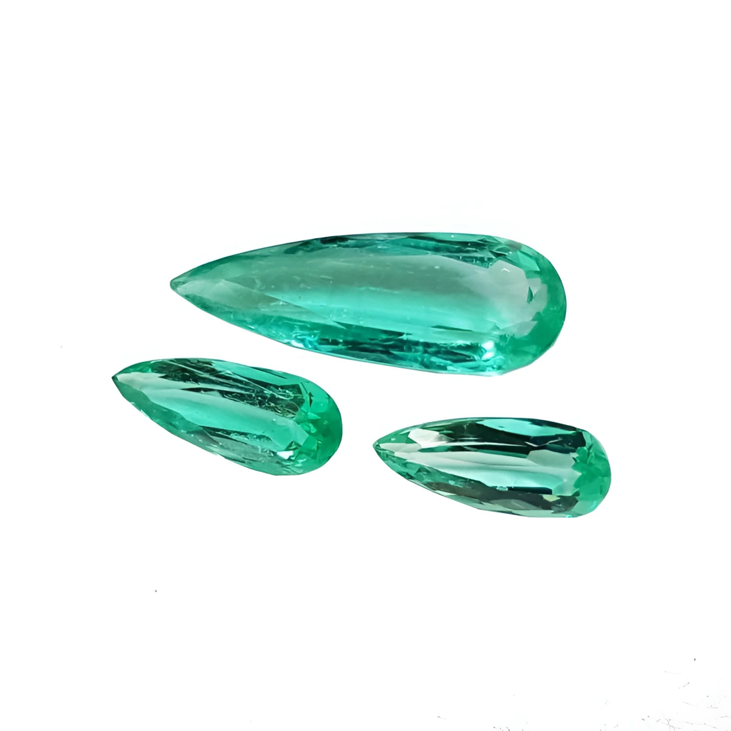 Three loose, pear-shaped Colombian emeralds with sparkling medium light green color.