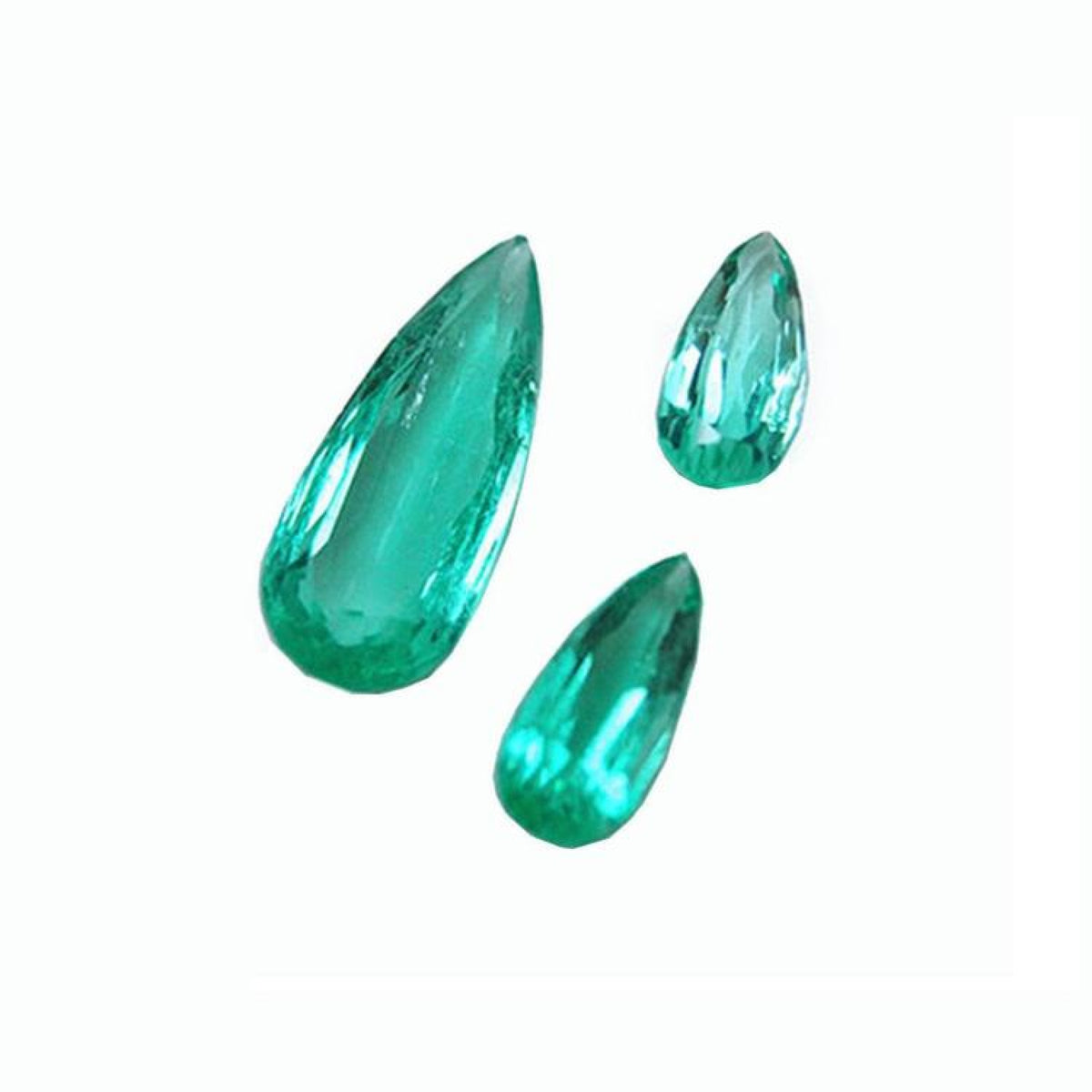 Three pear-shaped, medium light green Colombian emeralds, eye-clean and sparkling.
