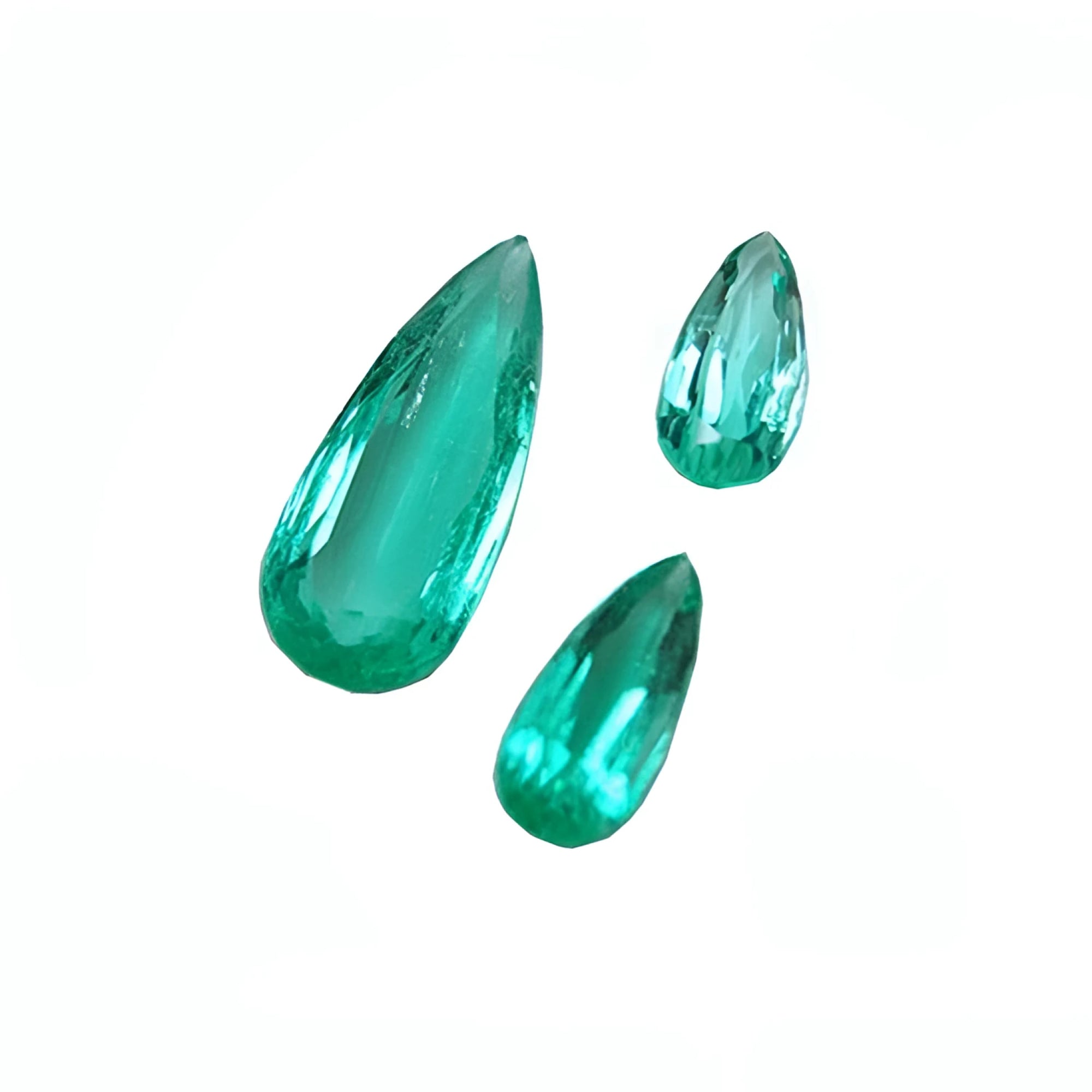Three pear-shaped, medium light green Colombian emeralds, eye-clean and sparkling.
