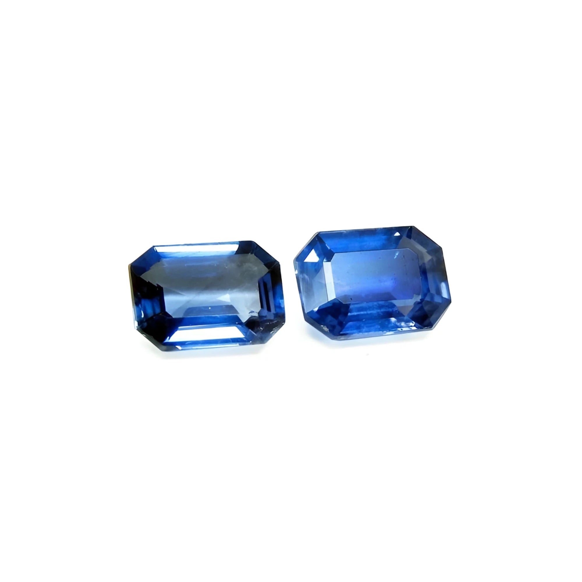 Matching pair of 2.09 ct. vibrant medium blue emerald-cut sapphires for earrings.